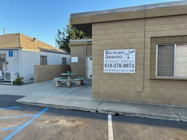 Exterior of Arroyo Law Center with signage and patio seating
